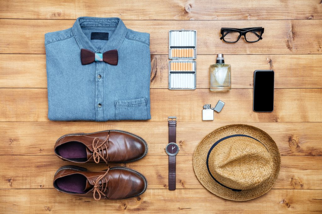 Travel concept shoes, shirt, mobile phone, watch, parfume, eyeglasses, hat