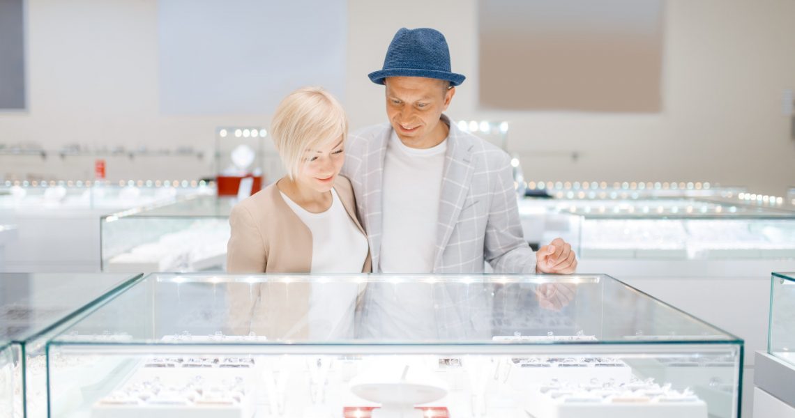 Love couple looking on jewels in jewelry store